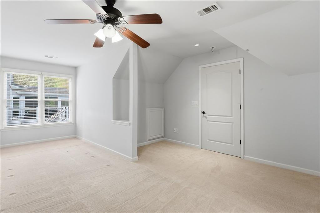 3875 Montvale Crossing Cumming, GA 30041 - Photo 22 of 53 en empty room with windows and ceiling fan