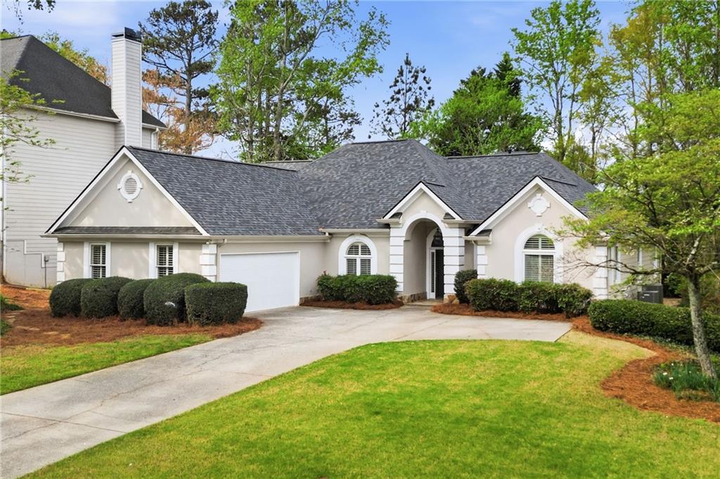 3875 Montvale Crossing Cumming, GA 30041 - Photo 3 of 53 a front view of a house with a yard and garage