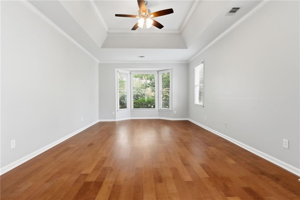 3875 Montvale Crossing Cumming, GA 30041 - Photo 31 of 53 an empty room with wooden floor fan and windows