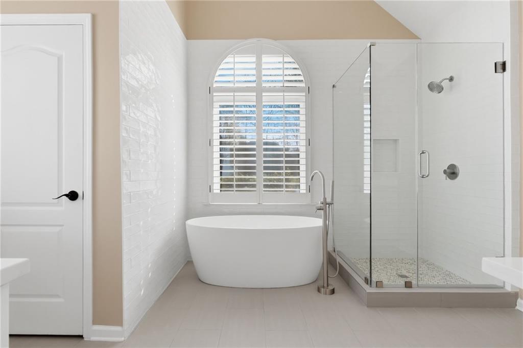 3875 Montvale Crossing Cumming, GA 30041 - Photo 32 of 53 a bathroom with a bathtub and shower