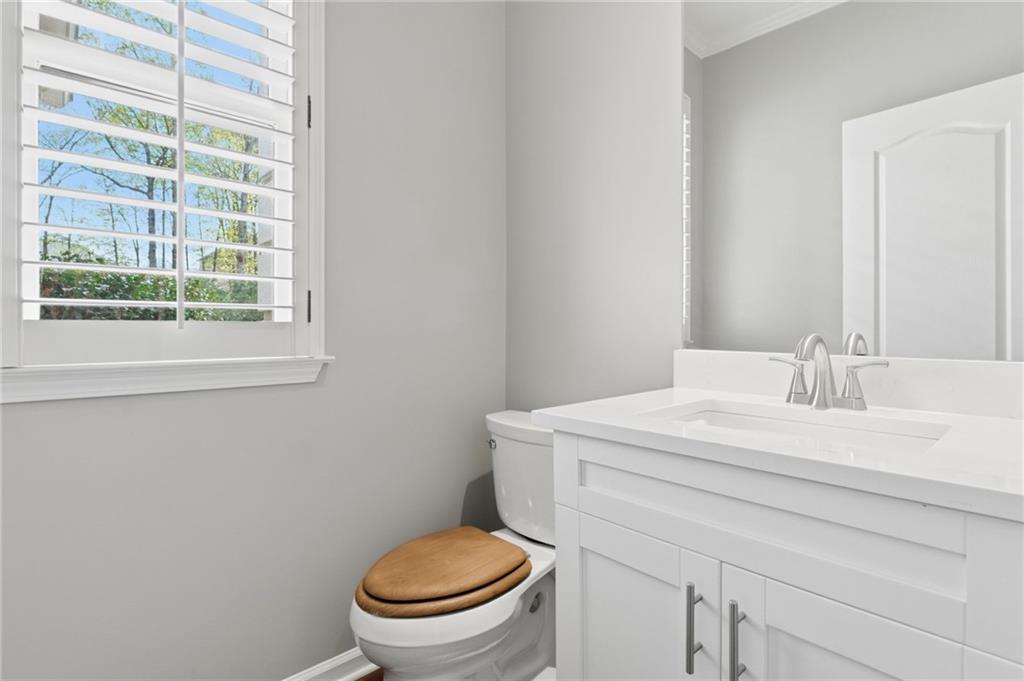 3875 Montvale Crossing Cumming, GA 30041 - Photo 35 of 53 a bathroom with a sink a toilet and a mirror