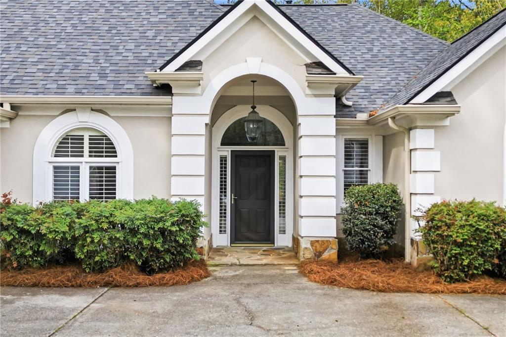 3875 Montvale Crossing Cumming, GA 30041 - Photo 4 of 53 a view of a brick house with large windows