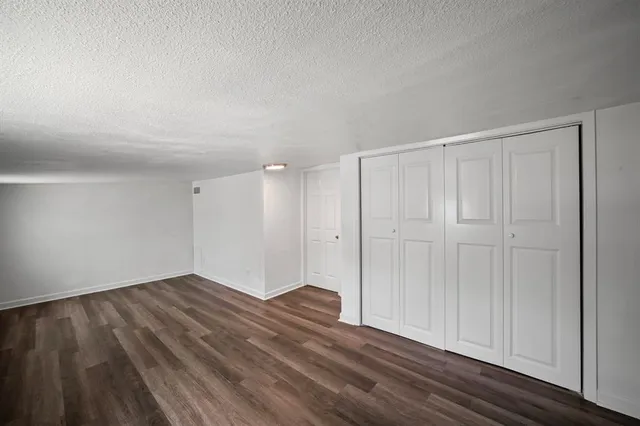 a view of an empty room and wooden floor