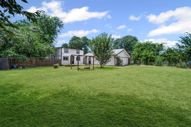 a view of a house with a yard and sitting area