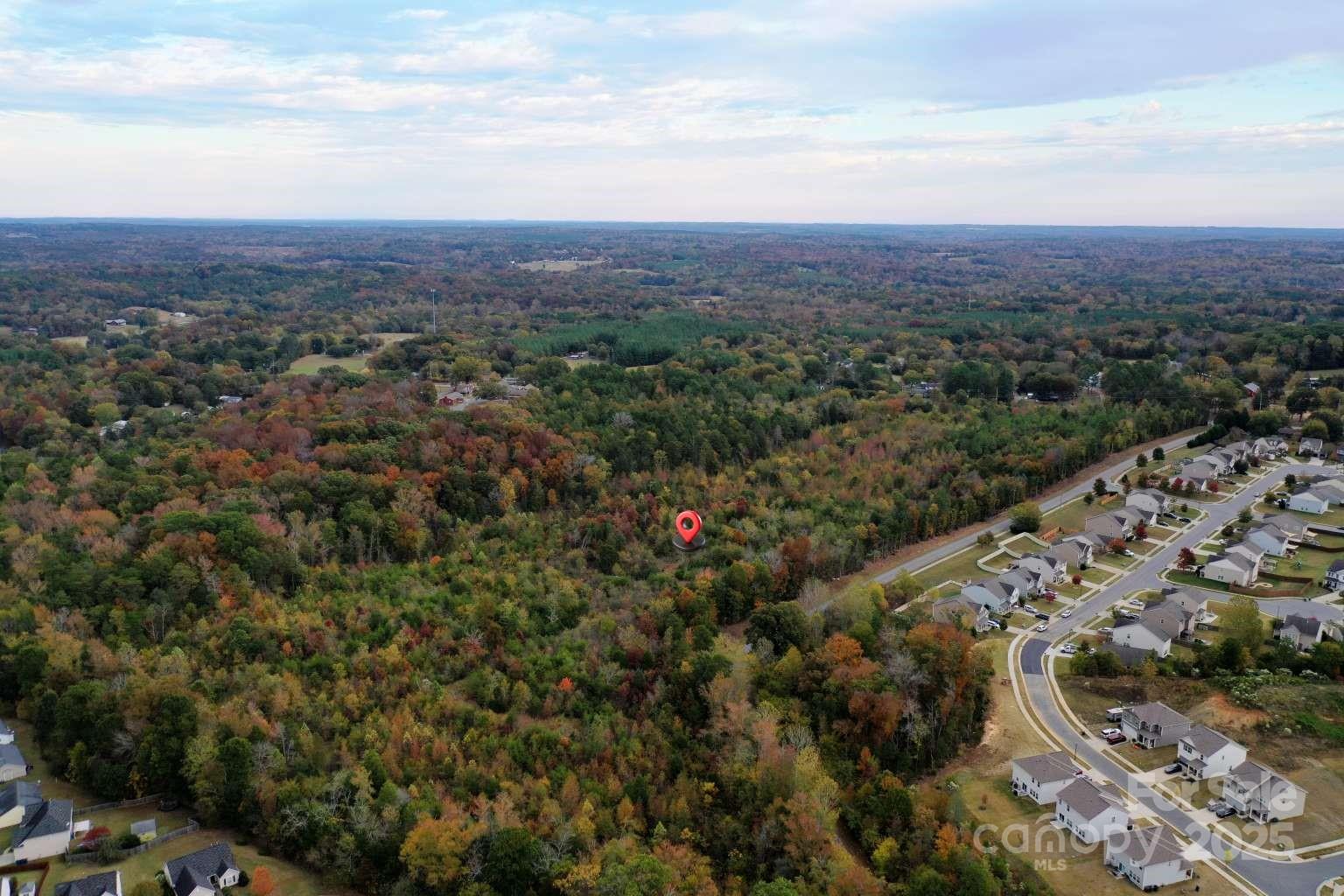 5582 Flowes Store Road Concord, NC 28025 - Photo 7 of 8 an aerial view of residential house and outdoor space