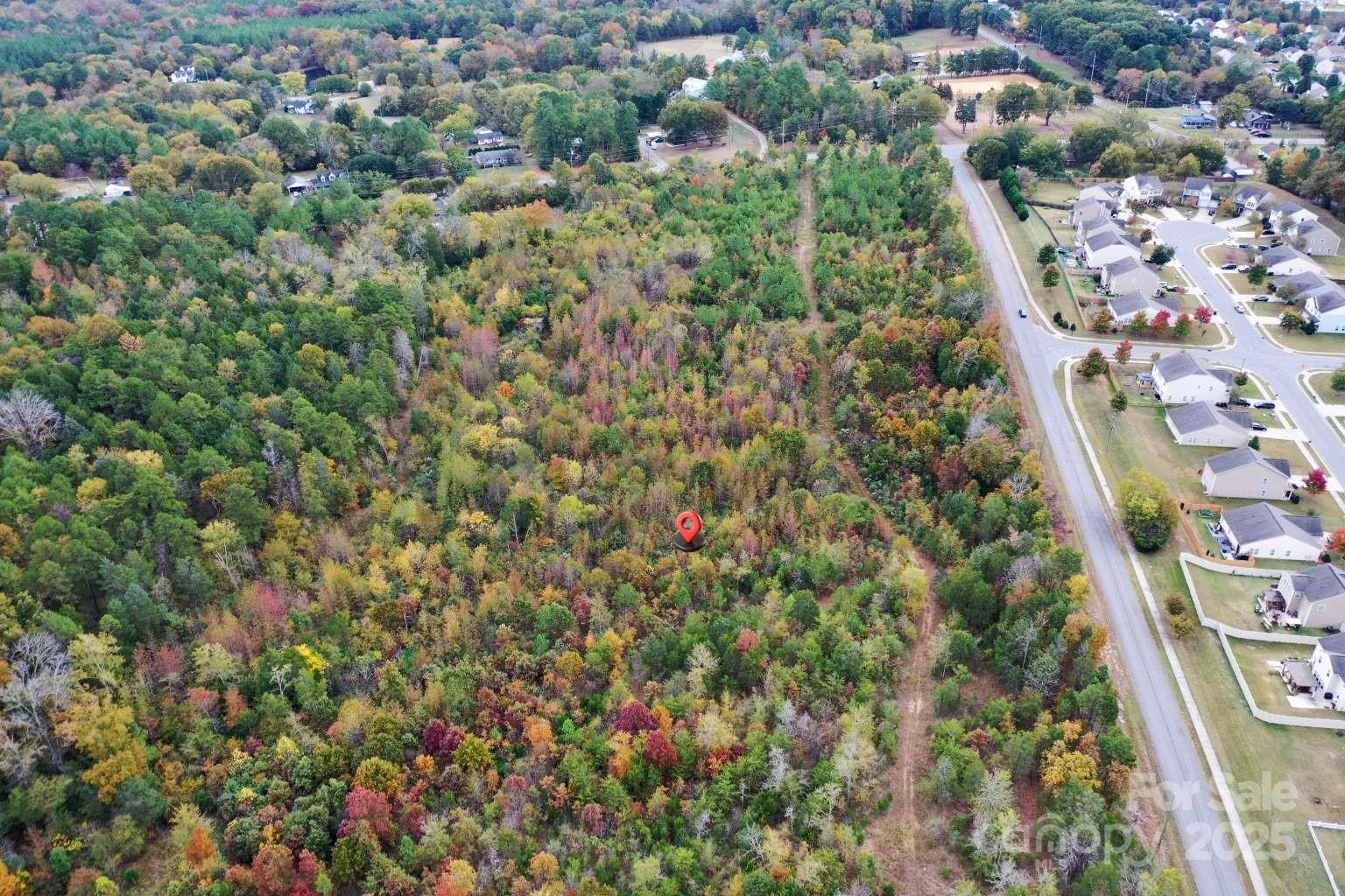5582 Flowes Store Road Concord, NC 28025 - Photo 8 of 8 an aerial view of residential houses with outdoor space and trees