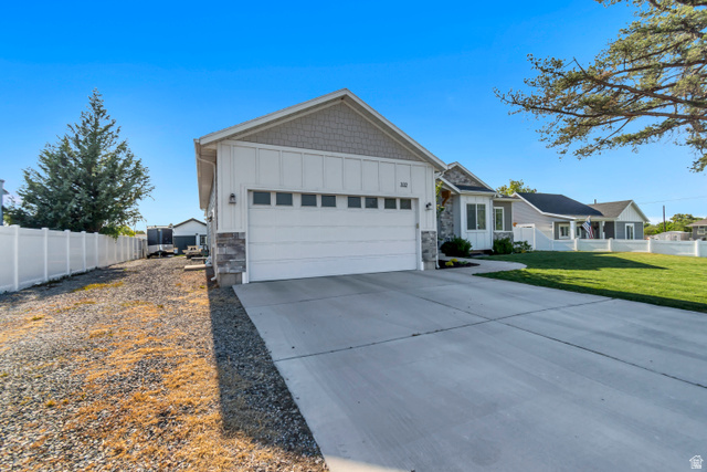 332 South 500 West Payson, UT 84651 - Photo 3 of 50 Contemporary home with a two-car garage, board and batten style cement board siding, and stone accents. Large shop at the end of gravel driveway provides the space of a third car garage