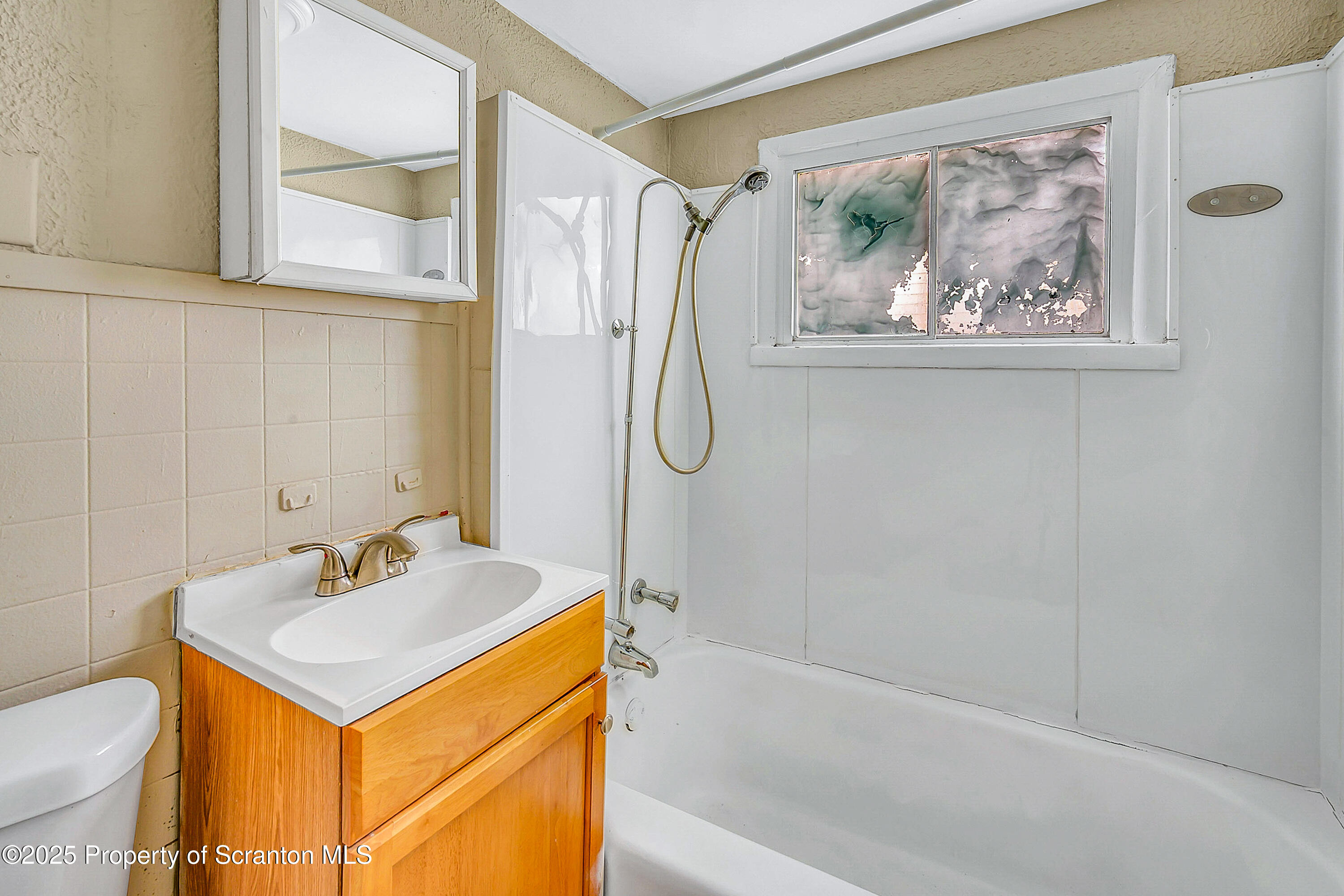 1007 Washburn Street, Unit 2 Scranton, PA 18504 - Photo 14 of 16 a bathroom with a sink a toilet and a bathtub