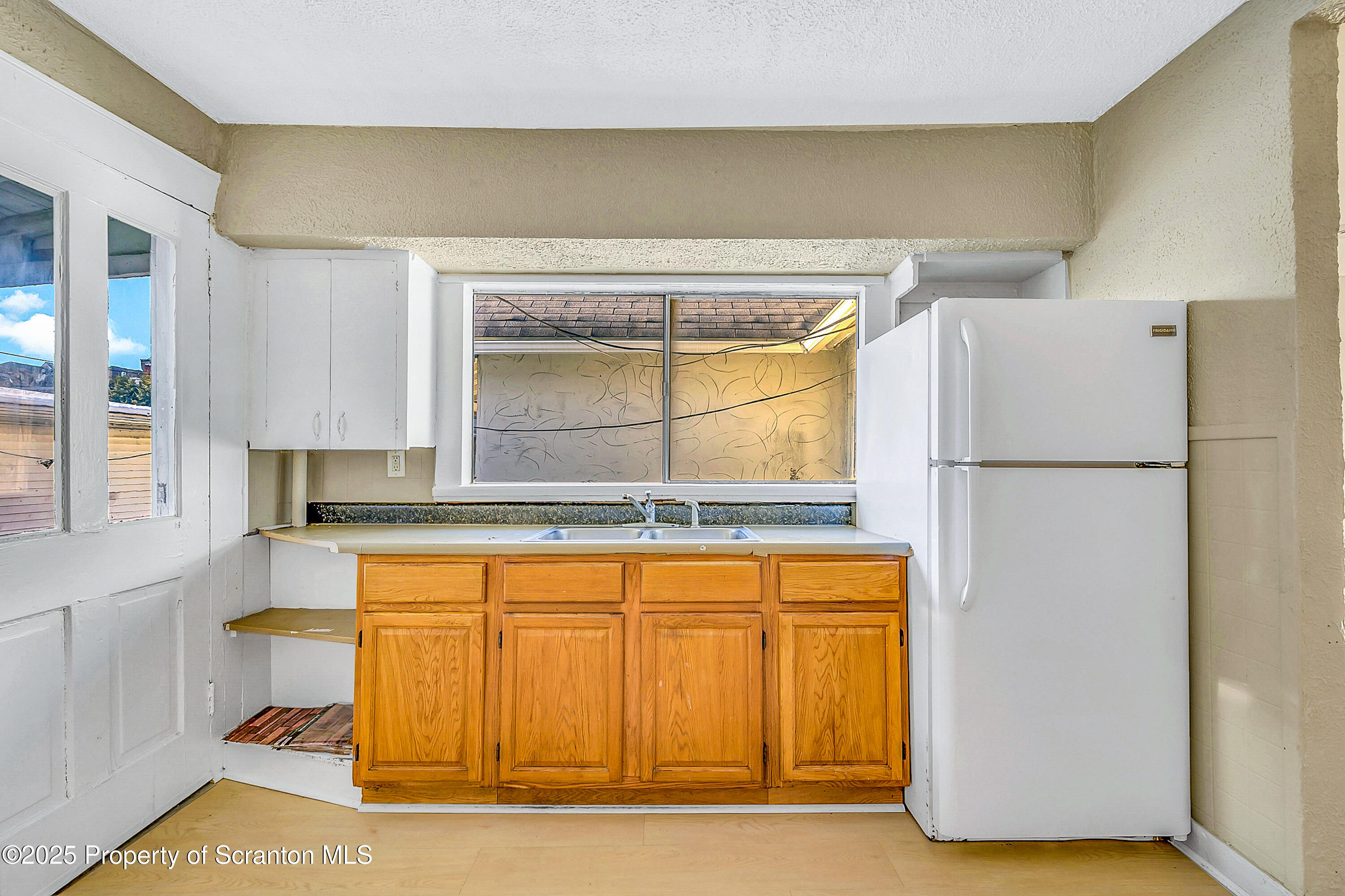 1007 Washburn Street, Unit 2 Scranton, PA 18504 - Photo 16 of 16 a kitchen with a refrigerator and a more cabinets