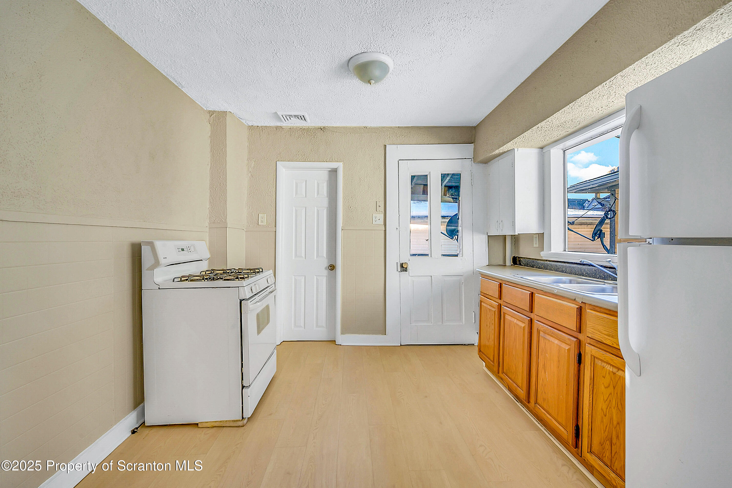 1007 Washburn Street, Unit 2 Scranton, PA 18504 - Photo 9 of 16 a kitchen with a refrigerator stove and sink