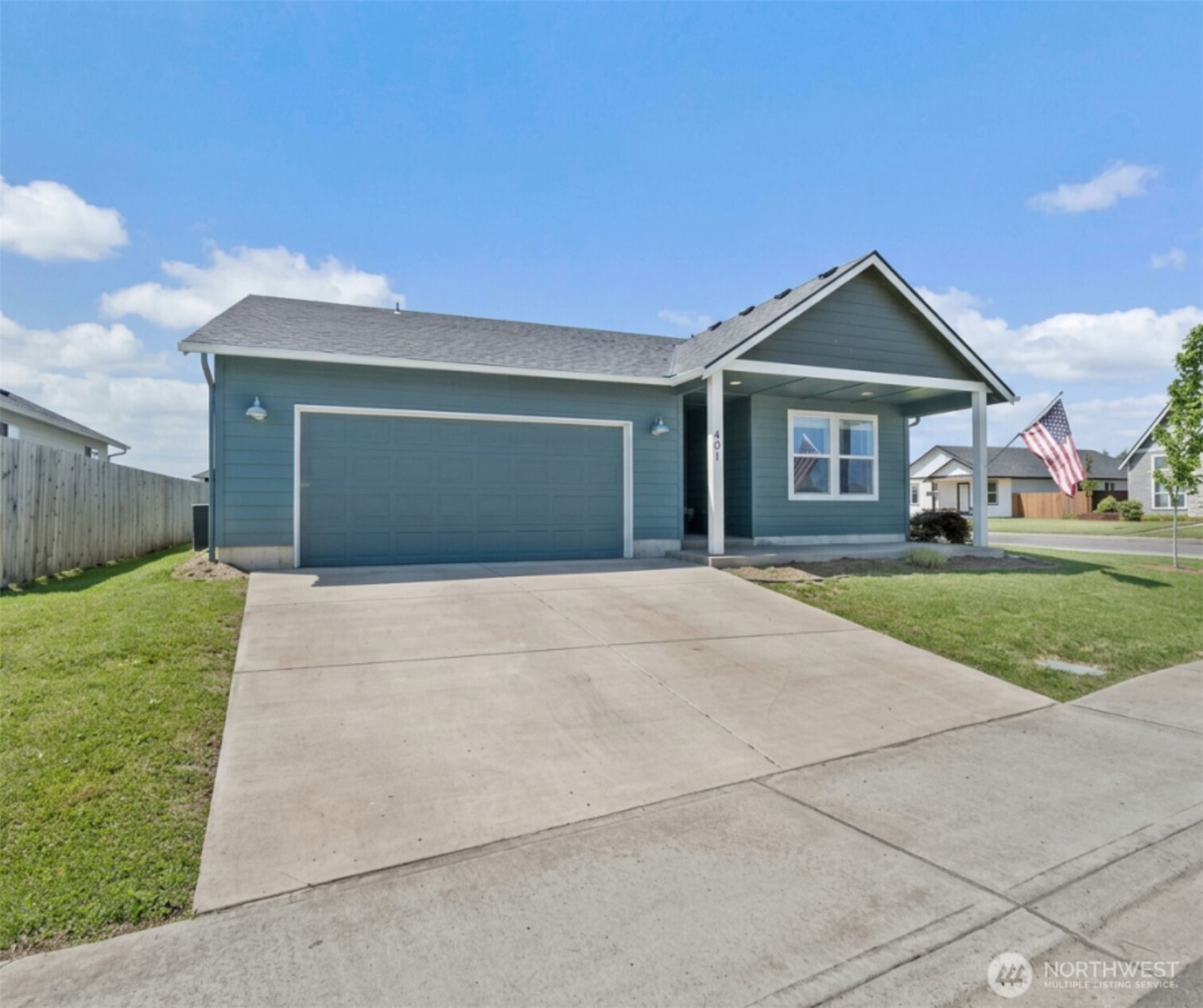 401 Cardinal Avenue Winlock, WA 98596 - Photo 1 of 39 a front view of a house with a yard and garage