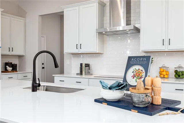 a kitchen with a stove a sink and a stove