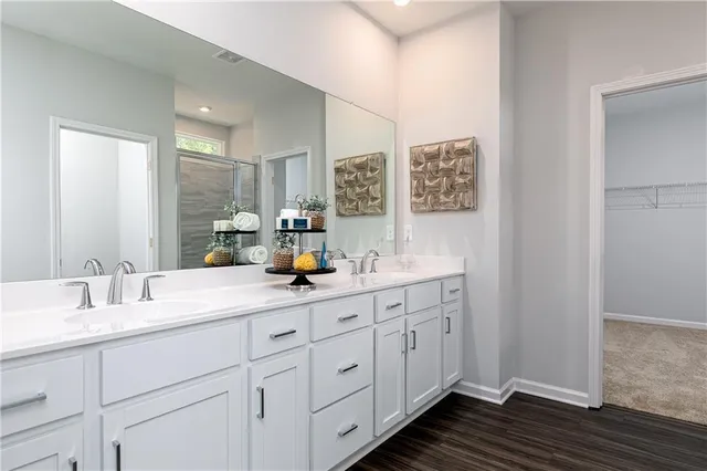 a bathroom with double sink and a mirror