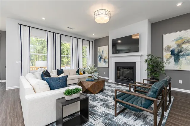 a living room with furniture fireplace and flat screen tv