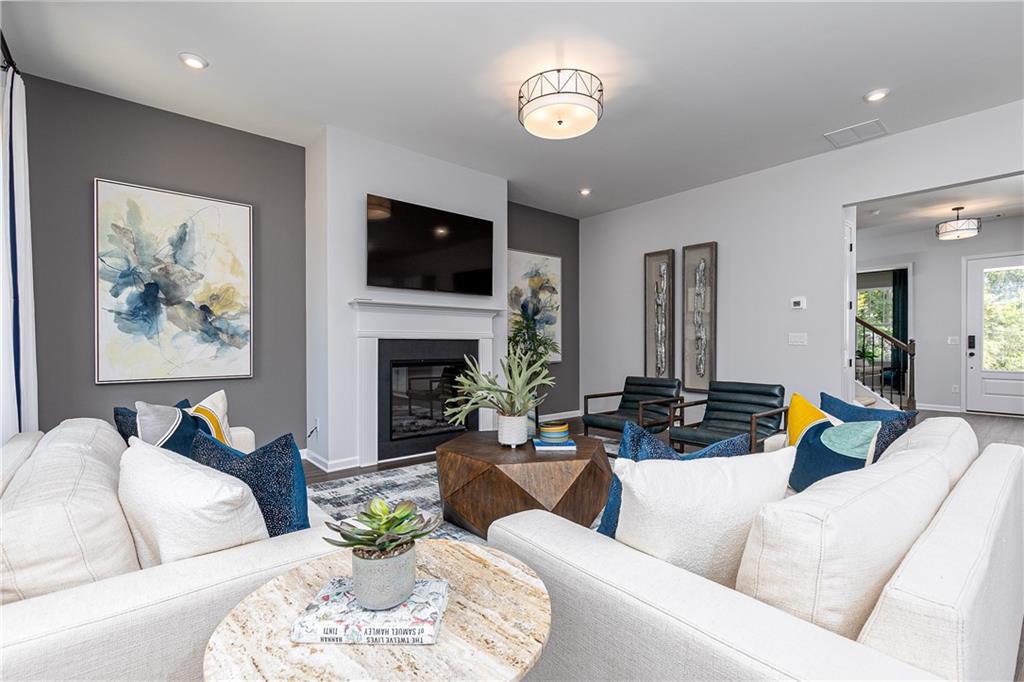 752 Coventry Cv Way Acworth, GA 30102 - Photo 9 of 34 a living room with furniture fireplace and a flat screen tv