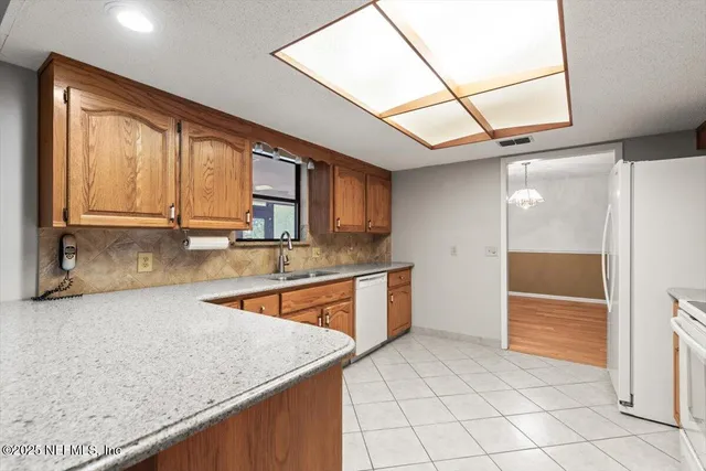 a view of a garden with wooden fence