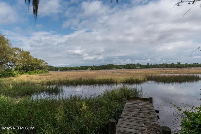 a view of a lake with houses in the back