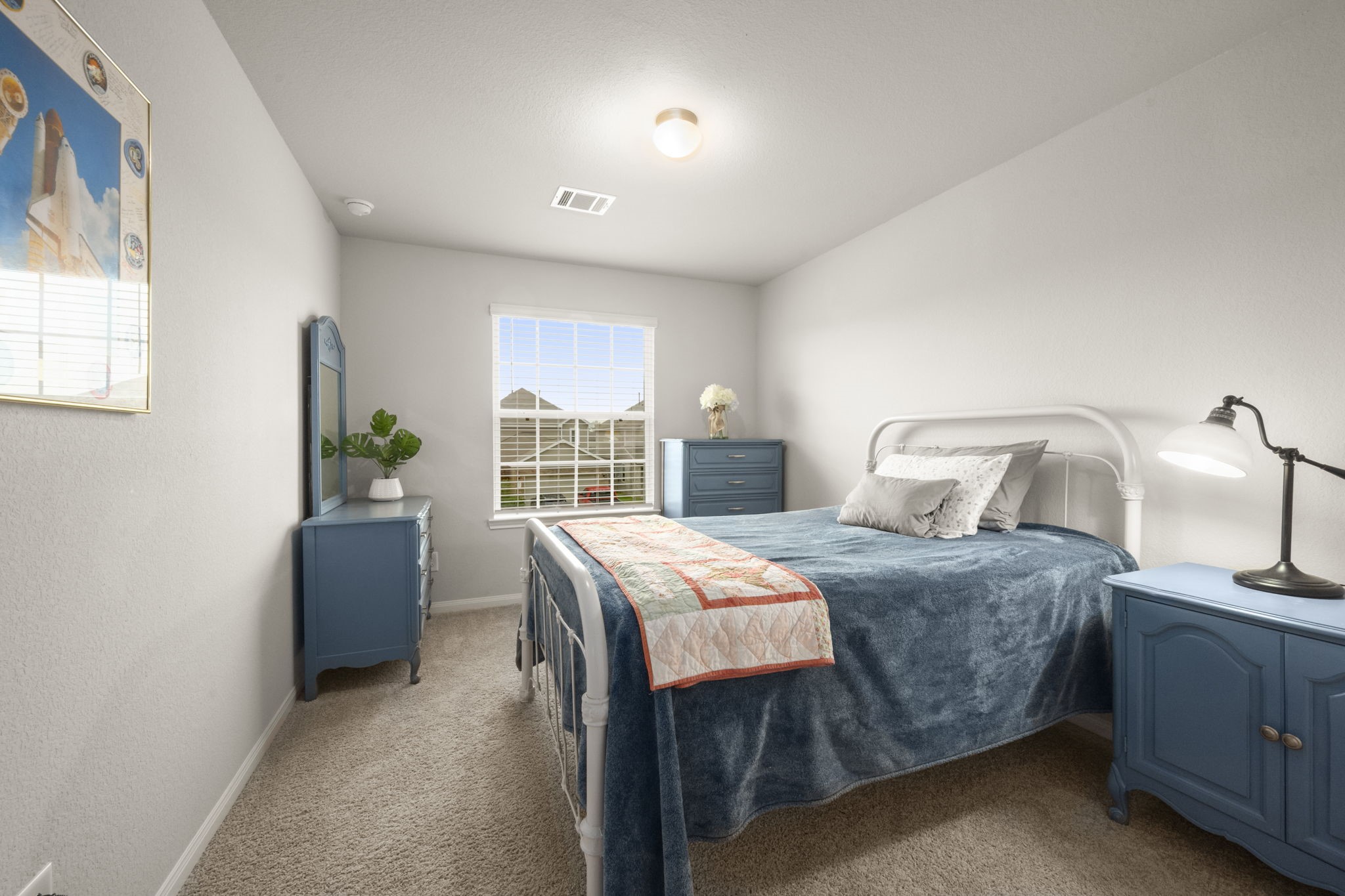 4915 Blue Jacaranda Way Spring, TX 77373 - Photo 21 of 30 Bedroom 3 - A cozy, well-lit bedroom with neutral walls, plush carpet and a window with a view of the front lawn.