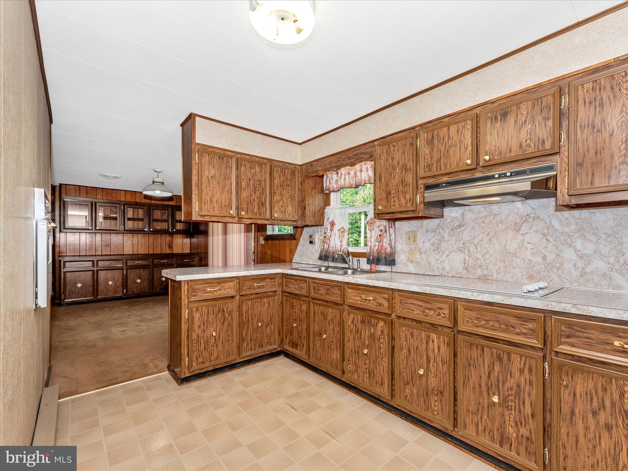 11732 Warner Road Keymar, MD 21757 - Photo 14 of 59 a kitchen with stainless steel appliances wooden cabinets and a sink