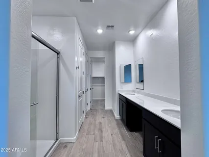 a large bathroom with a double vanity sink and a mirror