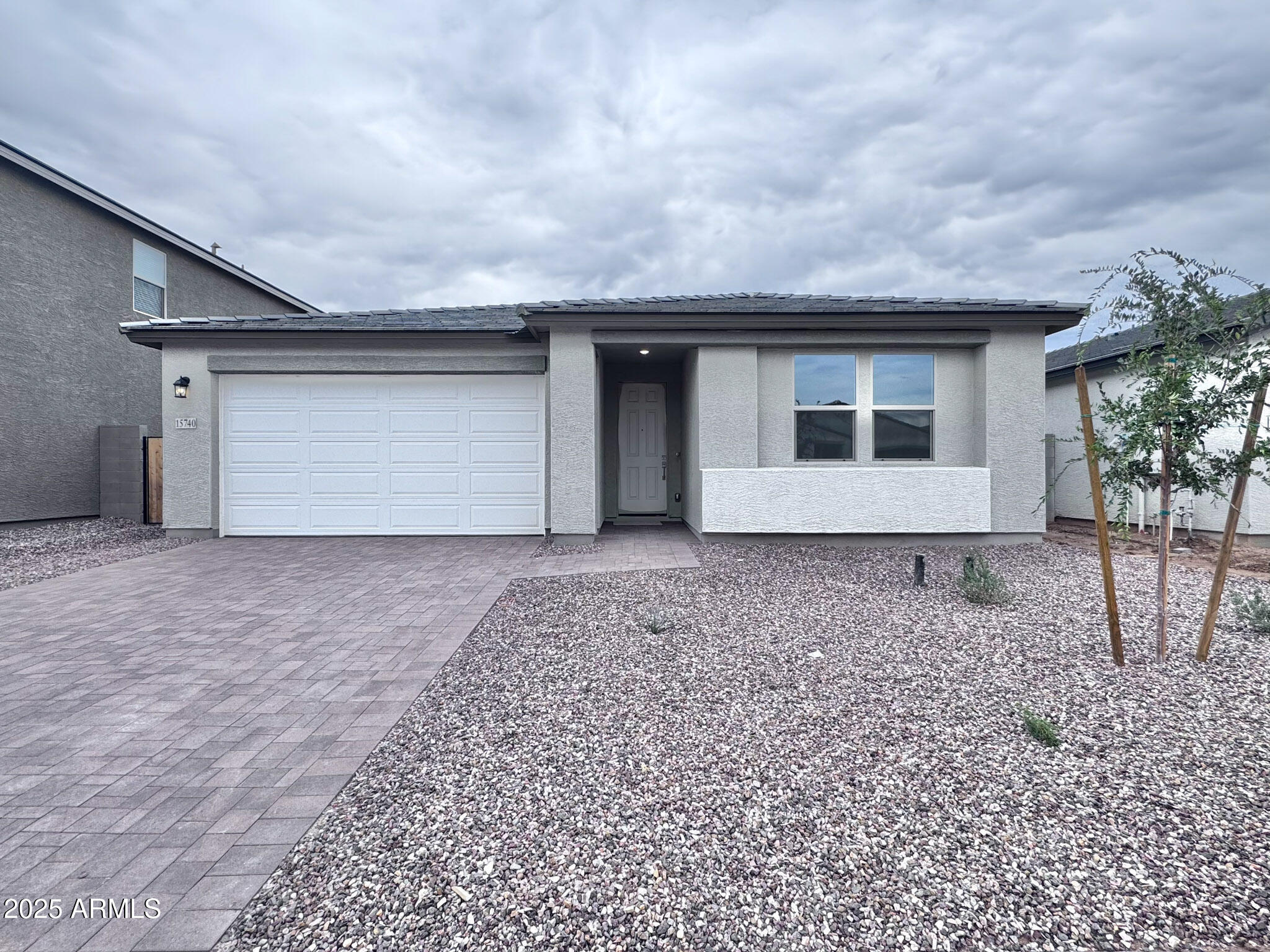 15740 West Camden Avenue Waddell, AZ 85355 - Photo 2 of 38 a view of a house with a yard and garage