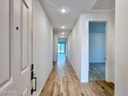 a view of hallway with wooden floor