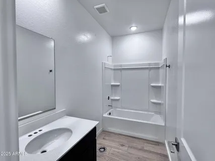 a bathroom with a sink vanity tub and shower