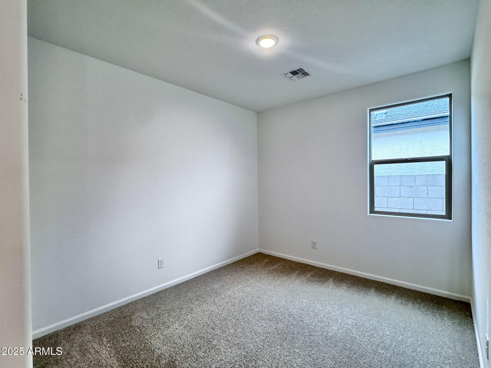 15740 West Camden Avenue Waddell, AZ 85355 - Photo 7 of 38 an empty room with a workbench