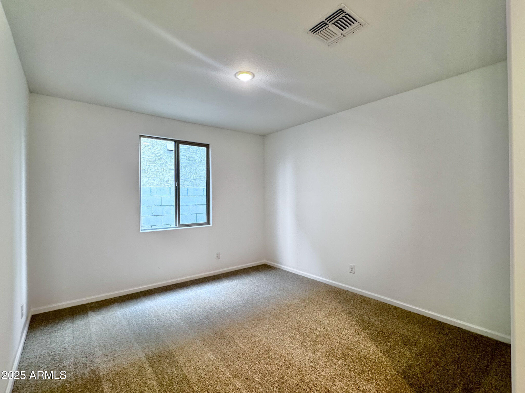 15740 West Camden Avenue Waddell, AZ 85355 - Photo 8 of 38 an empty room with a window