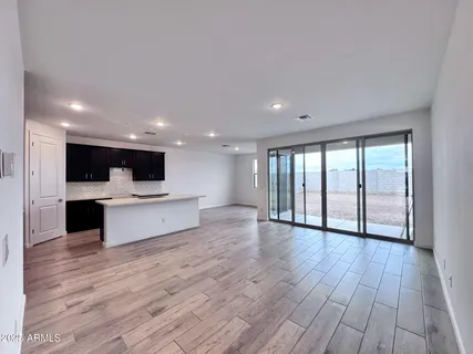 a view of kitchen with wooden floor and electronic appliances