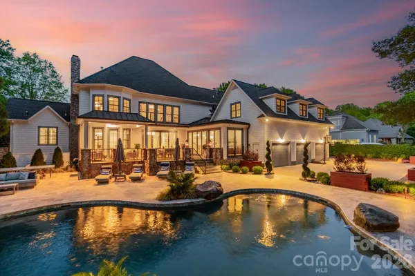 a view of a house with swimming pool and sitting area