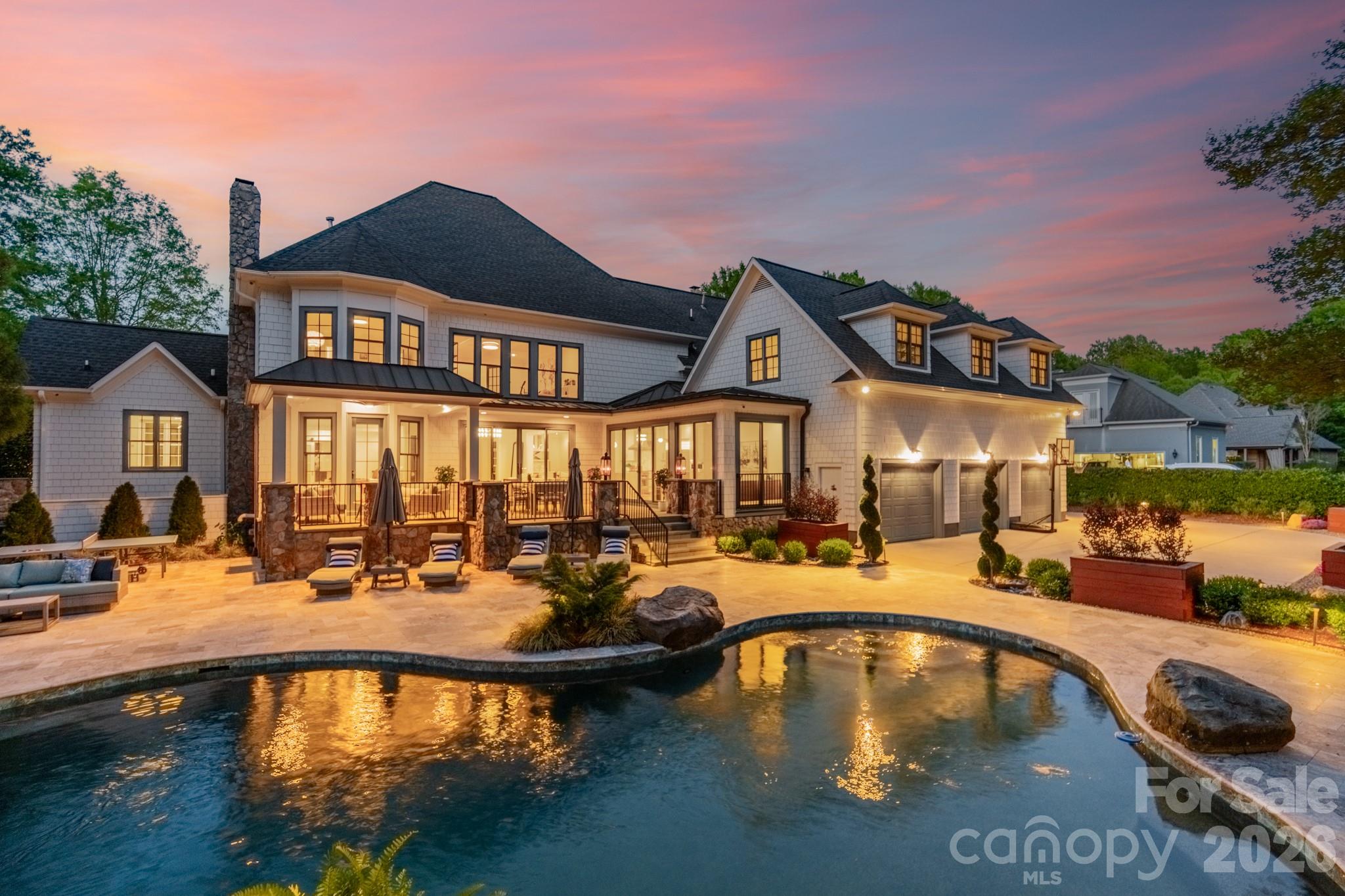a view of a house with swimming pool and sitting area