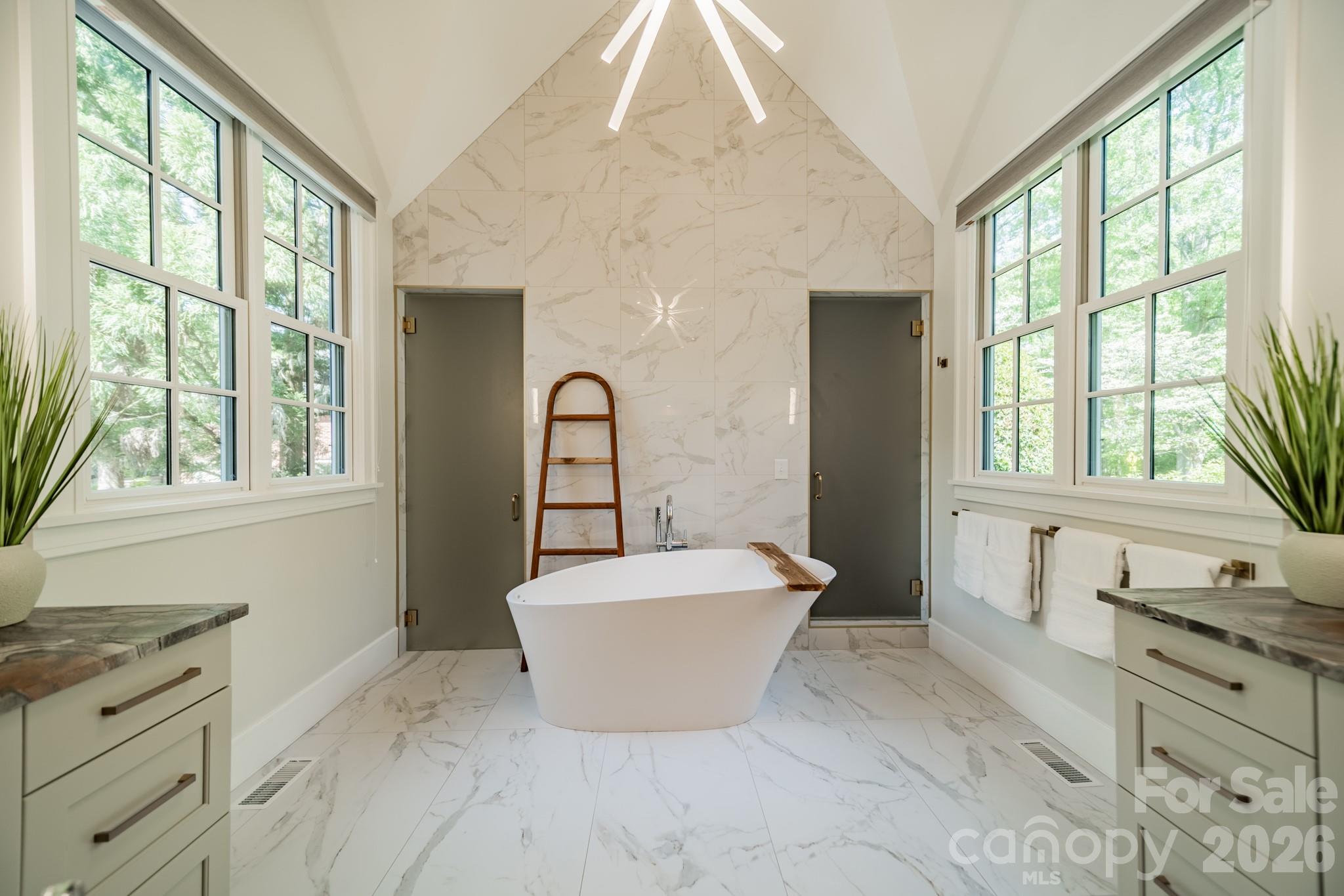 5400 Colony Road Charlotte, NC 28226 - Photo 16 of 48 a spacious bathroom with a tub sink and mirror