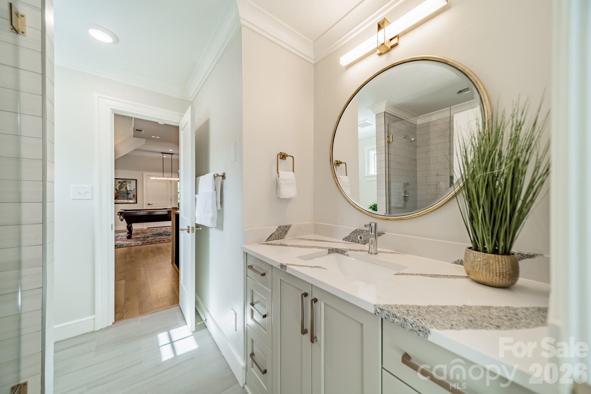 5400 Colony Road Charlotte, NC 28226 - Photo 26 of 48 a bathroom with a granite countertop sink a mirror and vanity