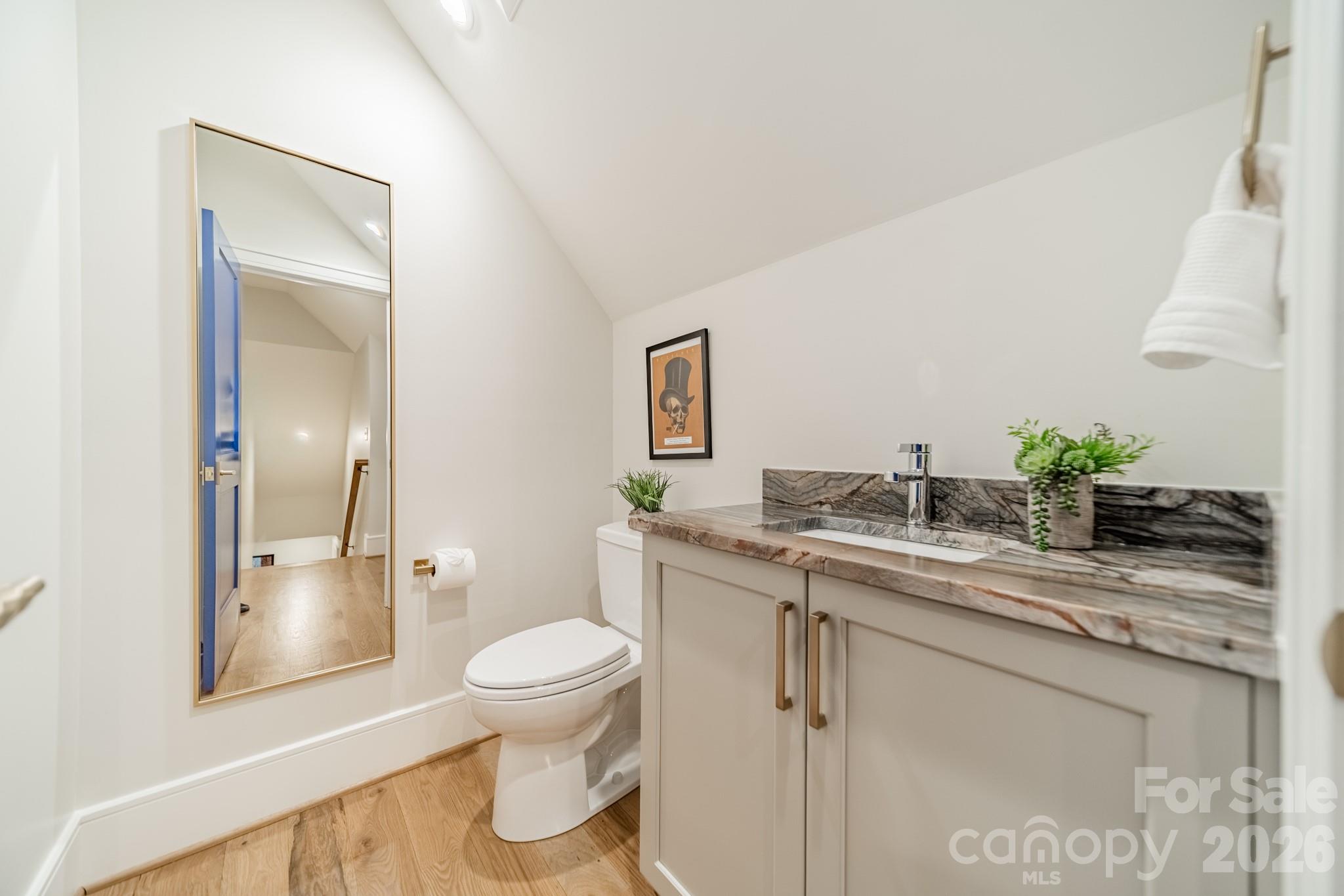 5400 Colony Road Charlotte, NC 28226 - Photo 34 of 48 a bathroom with a granite countertop sink a toilet and shower