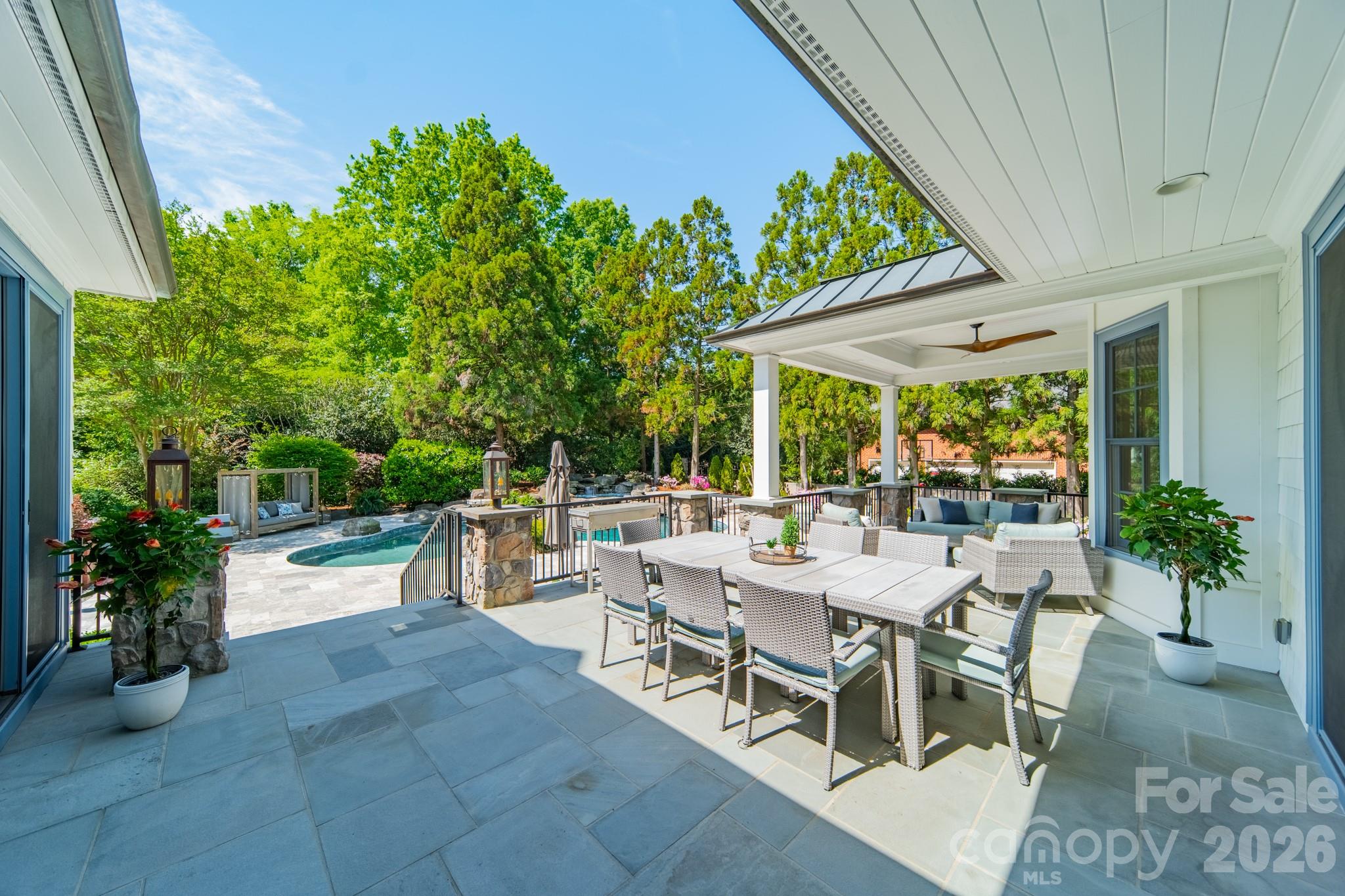 5400 Colony Road Charlotte, NC 28226 - Photo 38 of 48 a view of a patio with couches and table and chairs under an umbrella