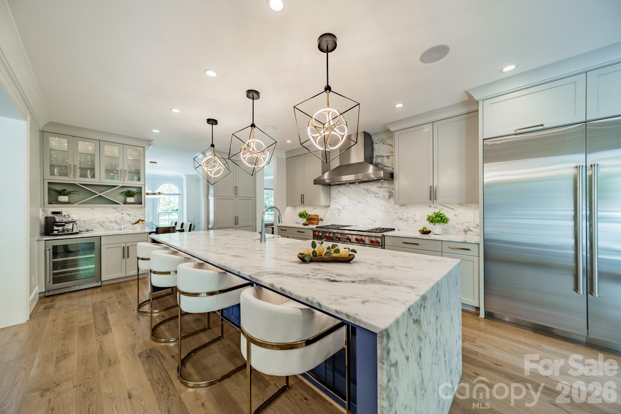 5400 Colony Road Charlotte, NC 28226 - Photo 6 of 48 a kitchen with a table chairs and stainless steel appliances