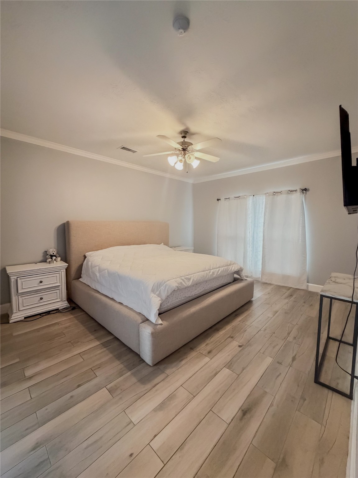 30707 Lily Trace Court Spring, TX 77386 - Photo 11 of 23 a bedroom with a large bed and a flat tv screen on dresser