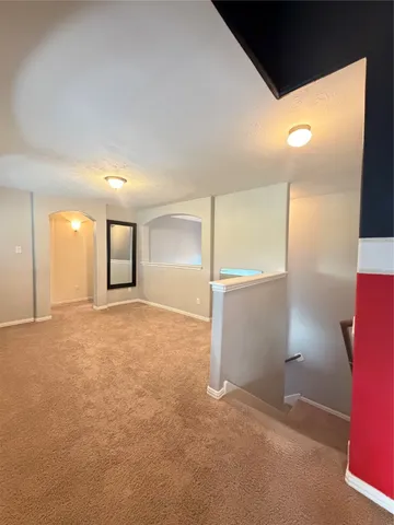 a view of an empty room with a kitchen