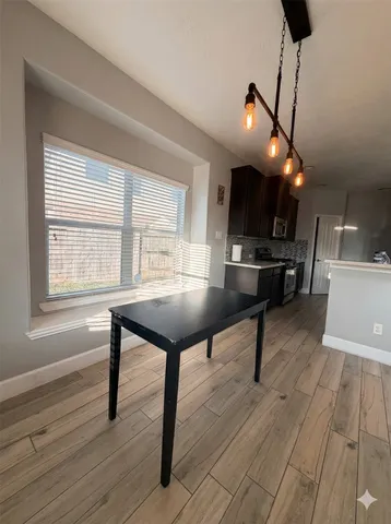 a view of an entryway of a house with wooden floor