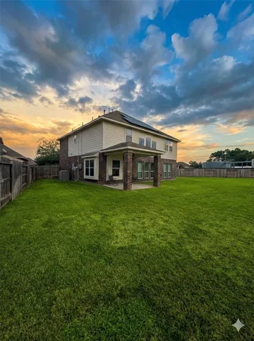 a view of a house with a yard and sitting area