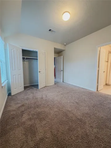 a view of an empty room and closet area