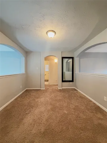 an empty room with windows and closet
