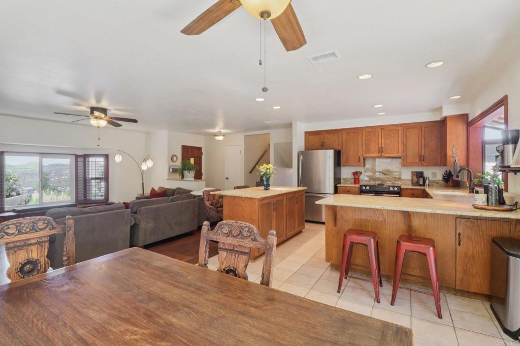 1921 Via Corina Alpine, CA 91901 - Photo 21 of 62 a living room with stainless steel appliances kitchen island granite countertop furniture and a kitchen view