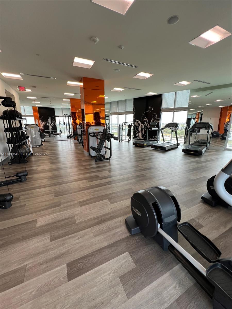 2000 Metropica Way, Unit 2108 Sunrise, FL 33323 - Photo 35 of 44 a view of a room with gym equipment and a table