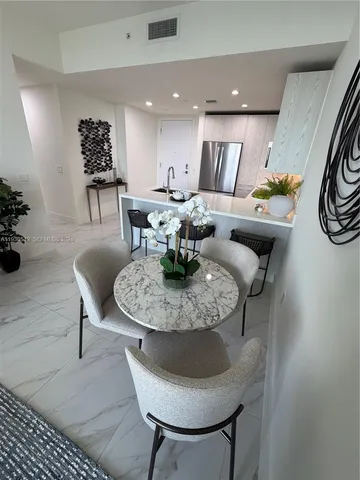 a living room with furniture and a lamp