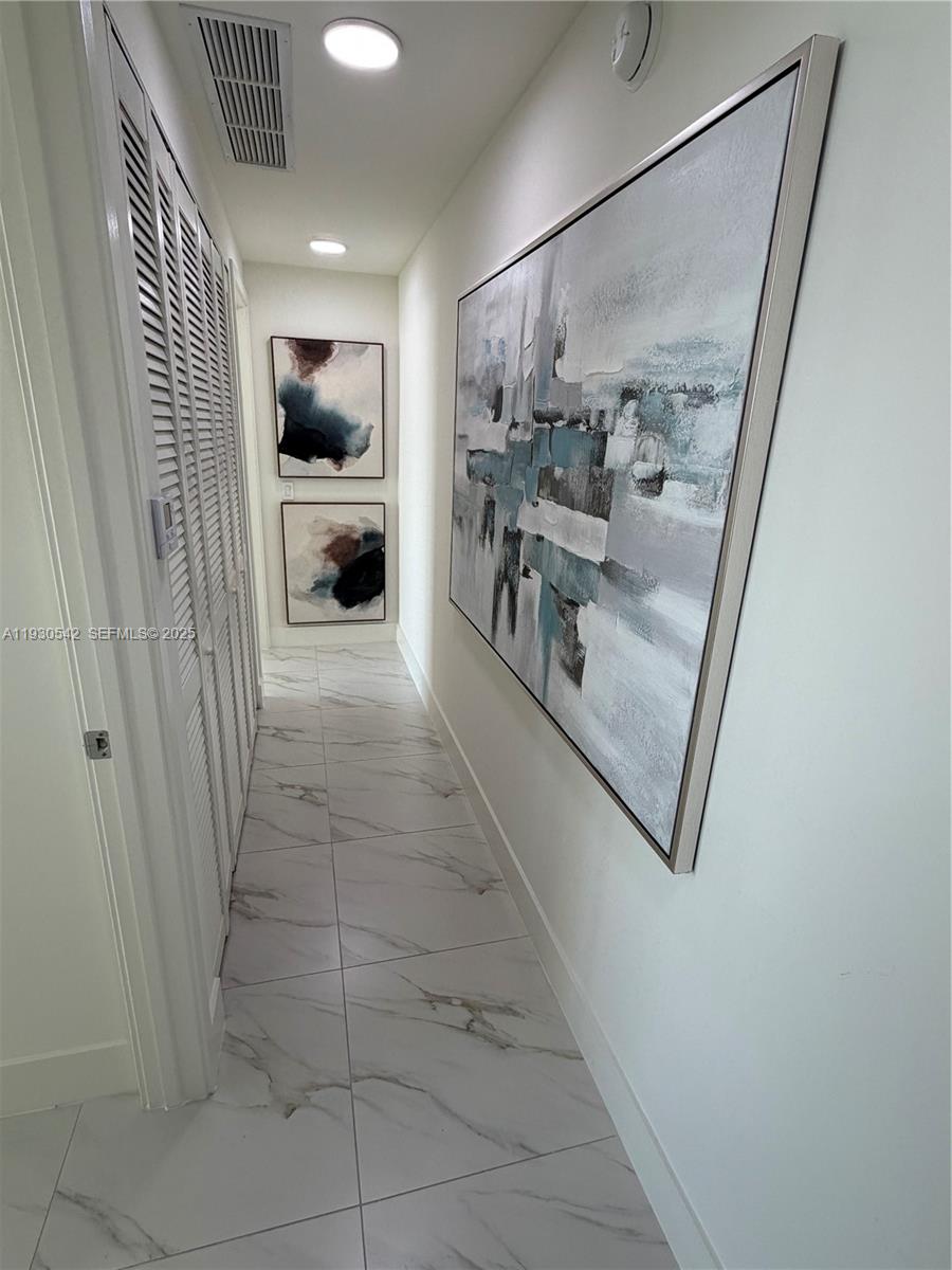 2000 Metropica Way, Unit 2108 Sunrise, FL 33323 - Photo 10 of 44 a view of a hallway and a livingroom with furniture