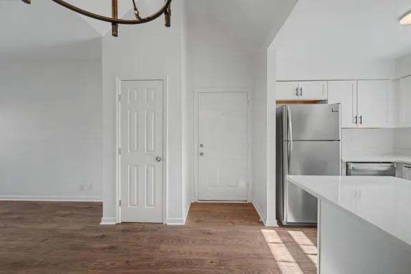 a kitchen with granite countertop a refrigerator and a sink