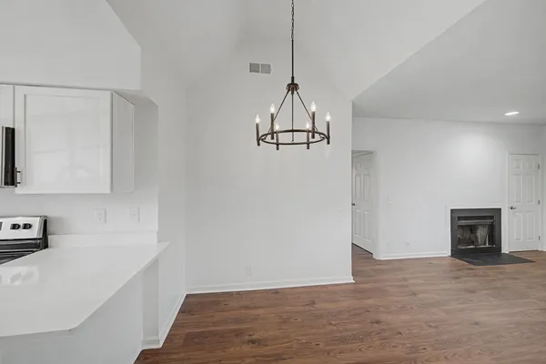 a view of a room with wooden floor and cabinets