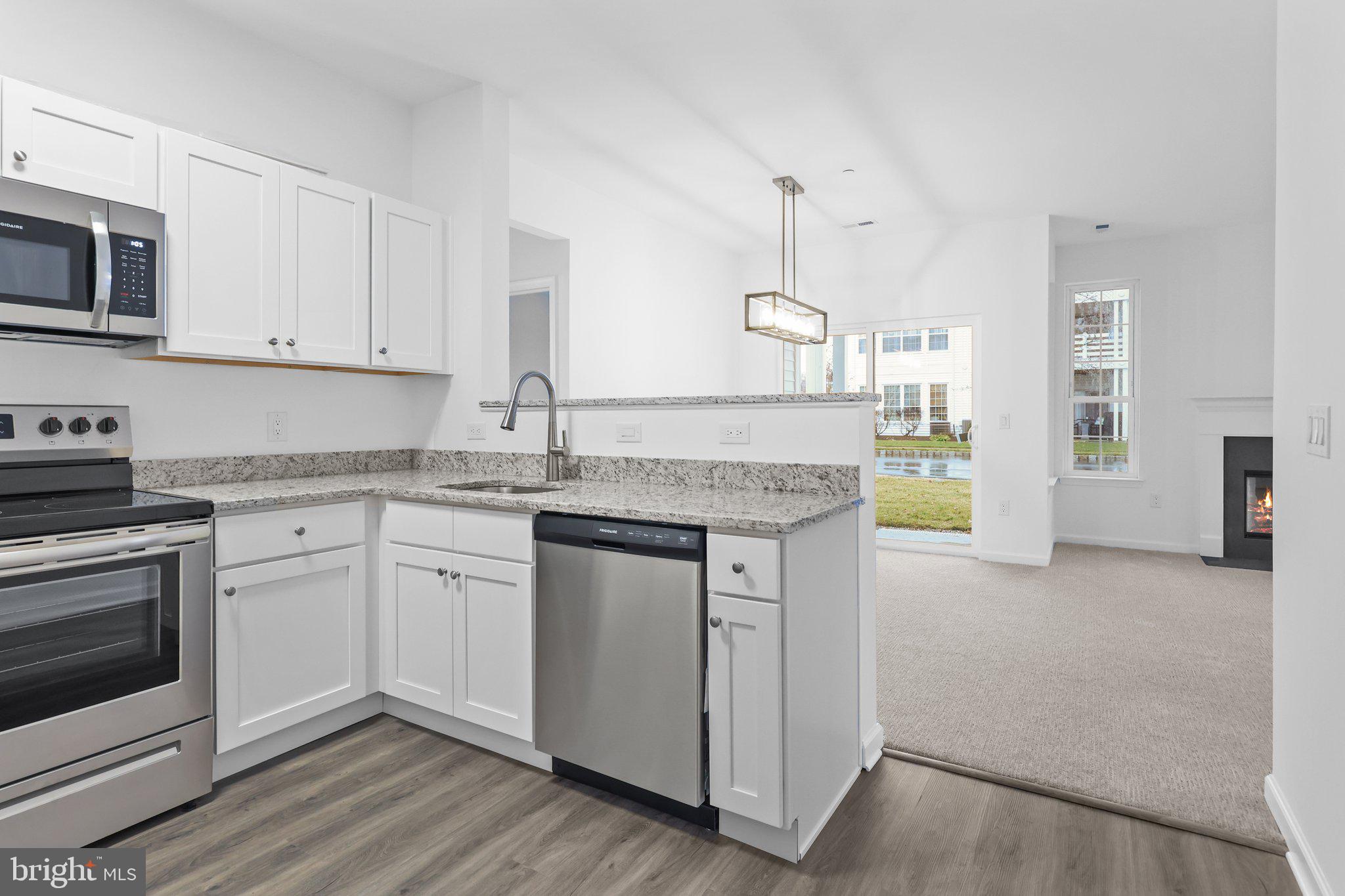 11112 Cornerstone Drive Yardley, PA 19067 - Photo 12 of 25 a kitchen with granite countertop white cabinets and white appliances